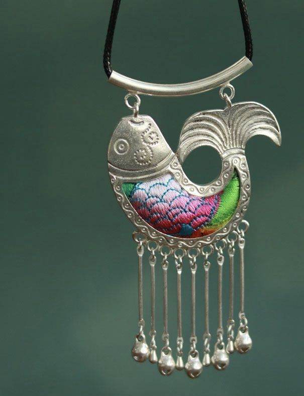 Silver fish pendant with colourful scales and hanging tassels