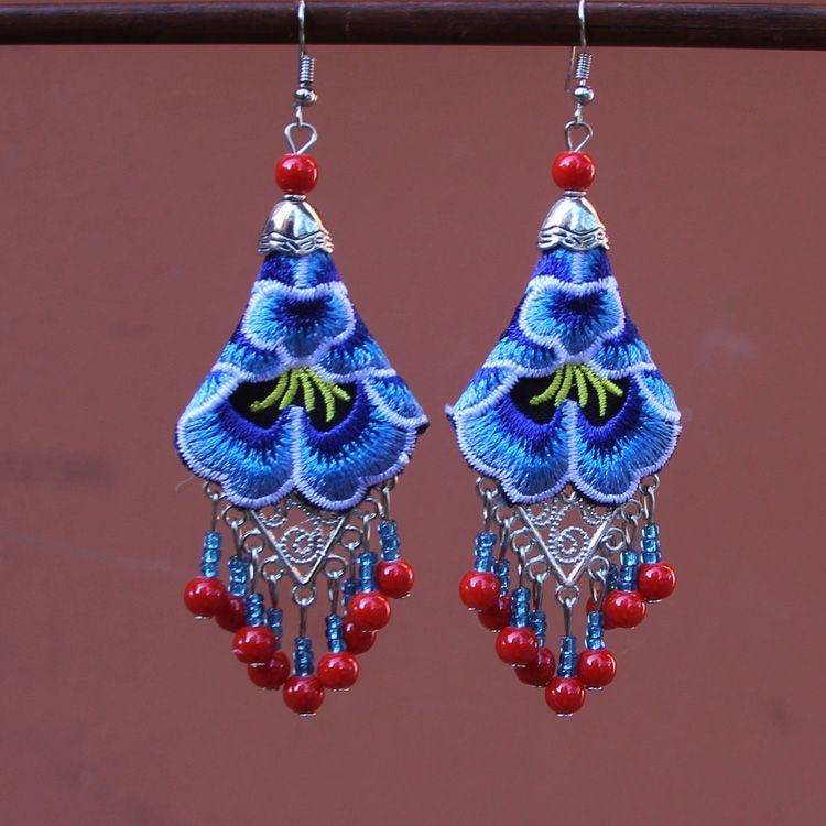 Blue floral embroidered earrings with silver tops and red beads