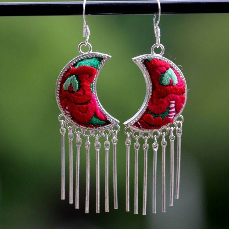 Crescent-shaped earrings with red embroidery and silver tassels