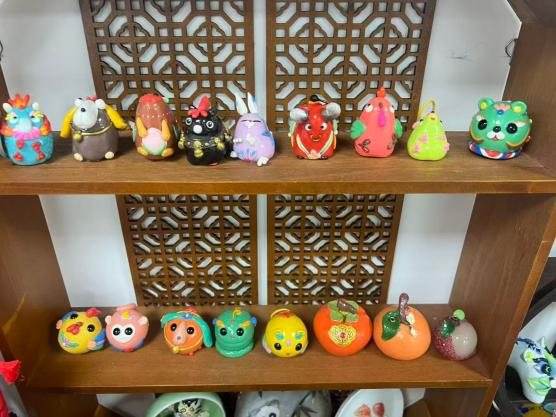 Shelves of small painted animal figures in bright colours