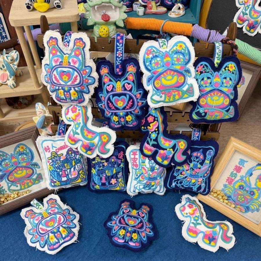 A group of small embroidered animal-shaped patches in bright colours