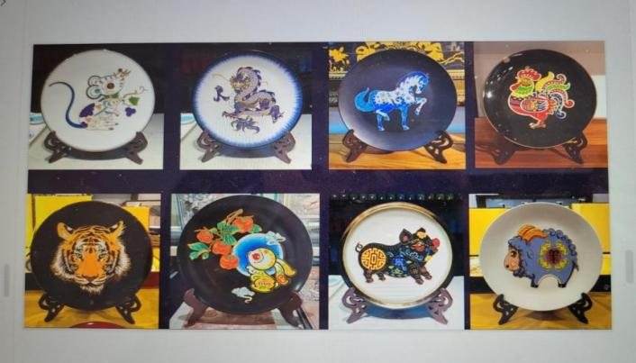Eight round plates on stands, each painted with a zodiac animal