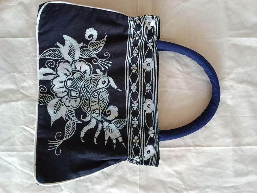 Indigo handbag with a white floral pattern