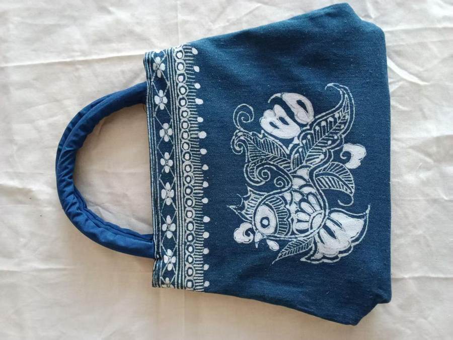 Indigo handbag with a white floral pattern and a round handle