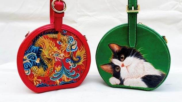 A red round bag with a hand-painted dragon